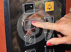 Female person pushing elevator button