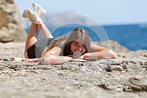 Female person resting on rocky beach