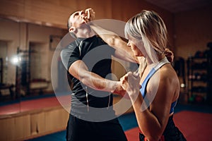 Female person on self-defense workout with trainer