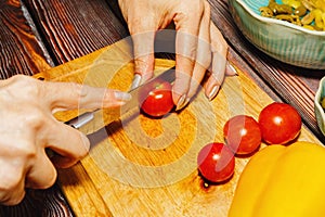 Female person slicing cherry tomatoes