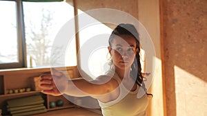 Female personal trainer doing asanas staying on matting in yogas studio