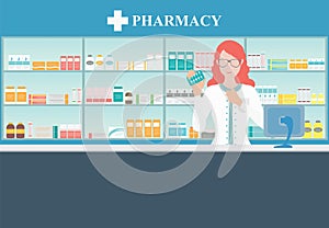 Female pharmacist at the counter in a pharmacy.