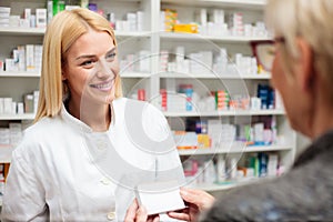 Female pharmacist explaining therapy details to senior female patient