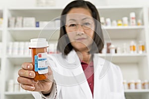 Female Pharmacist Holding Prescription Drugs photo