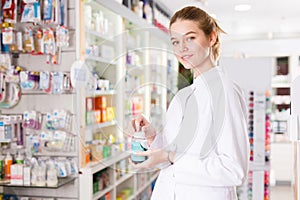 Female pharmacist offering help in choosing at counter in pharmacy