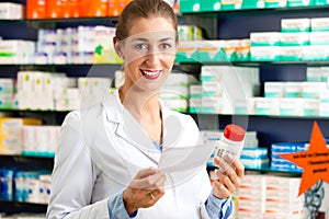 Female pharmacist in pharmacy with medicament