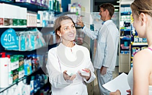 Female pharmacist in a white coat