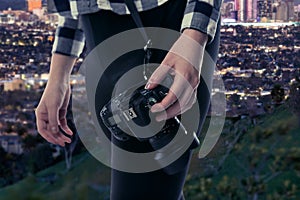 Female Photographer With Camera Looking at Los Angeles With Snow