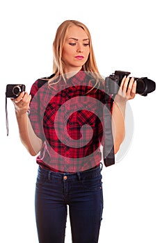 Female photographer choosing between two cameras - isolated on w