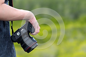 Female photographer holding dslr camera