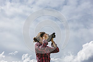 Female photographer in nature on a rock taking photos