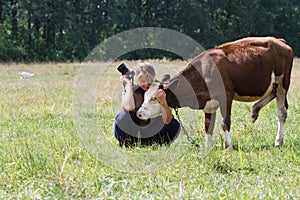 Female photographer pats calf cows