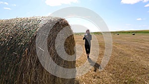 Female photographer shooting a haystack