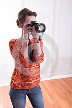 Female Photographer in the studio taking pictures