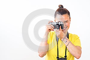 A female photographer using a vintage 35mm film rangefinder camera.