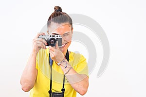 A female photographer using a vintage 35mm film rangefinder camera.