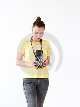 A female photographer using a vintage medium format TLR film camera.