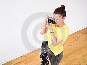 A female photographer using a vintage rangefinder 35mm film camera.