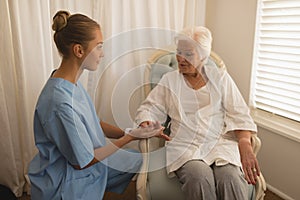 Female physician consoling senior woman