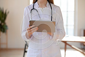 Female physician consult patient online on tablet