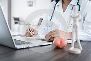 Female Physician Doctor Working at Her Desk in Examination Room, Close-Up Portrait of Medical Doctor Consulting and Diagnose