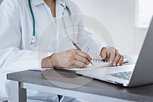 Female Physician Doctor Working at Her Desk in Examination Room, Close-Up Portrait of Medical Doctor Consulting and Diagnose