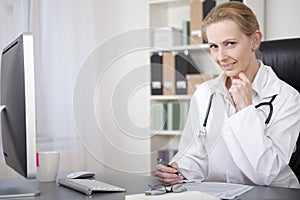 Female Physician on her Table Writing Reports