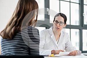 Female physician listening to her patient during consultation