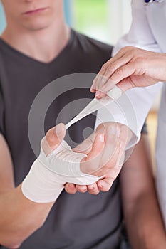Female physician parcels man's wrist photo