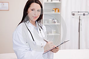 Female physician taking notes