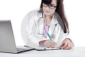 Female physician write medical report 1