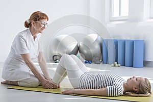 Female physiotherapist working with child