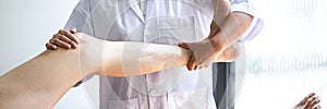 Female Physiotherapist working examining treating injured leg of male patient, Doing exercises the Rehabilitation therapy pain his