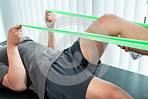 Female Physiotherapist working examining treating injured leg of patient, Doing exercises the Rehabilitation therapy pain his in