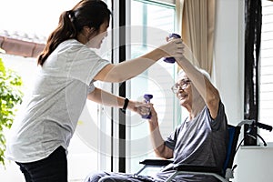 Female physiotherapist working or work out with a senior patient,old elderly exercising with dumbbells,asian caregiver assisting