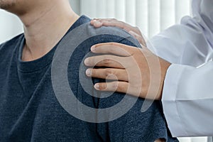 Female physiotherapists provide physical assistance to male patients with shoulder injuries massage their shoulders for muscle