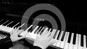 Female pianist hands pressing ivory keys, playing nice piano music at concert