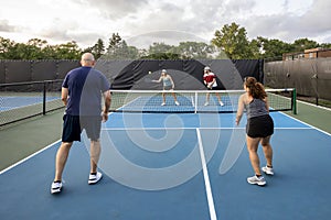 Female Pickleball Player Returns Ball at Net