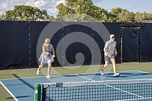 Female Pickleball Player Returns a Drive