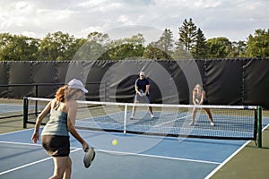 Female Pickleball Player Returns a Drive