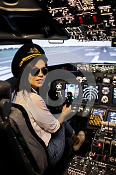 Female pilot the captain of the plane prepares for take-off in the plane cockpit.