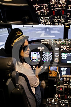 Female pilot the captain of the plane prepares for take-off in the plane cockpit.