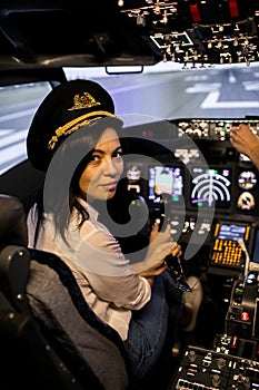 Female pilot the captain of the plane prepares for take-off in the plane cockpit.