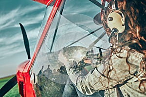 A female pilot in the cockpit of a small plane