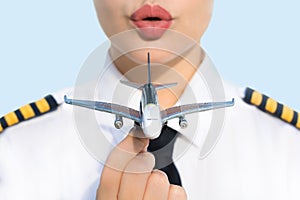 Pretty pilot captain woman and airplane at the airport. Aviation commercial