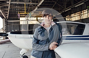 Female pilot posing in the hangar