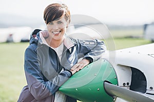 Female pilot posing with her plane