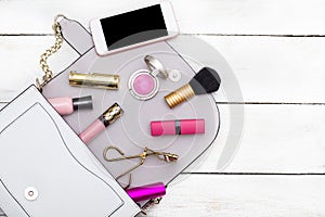 Female pink accessories on a white wooden background