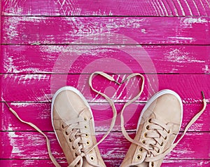 Female pink sneakers with unbound laces