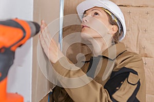 Female plasterer at indoor wall work